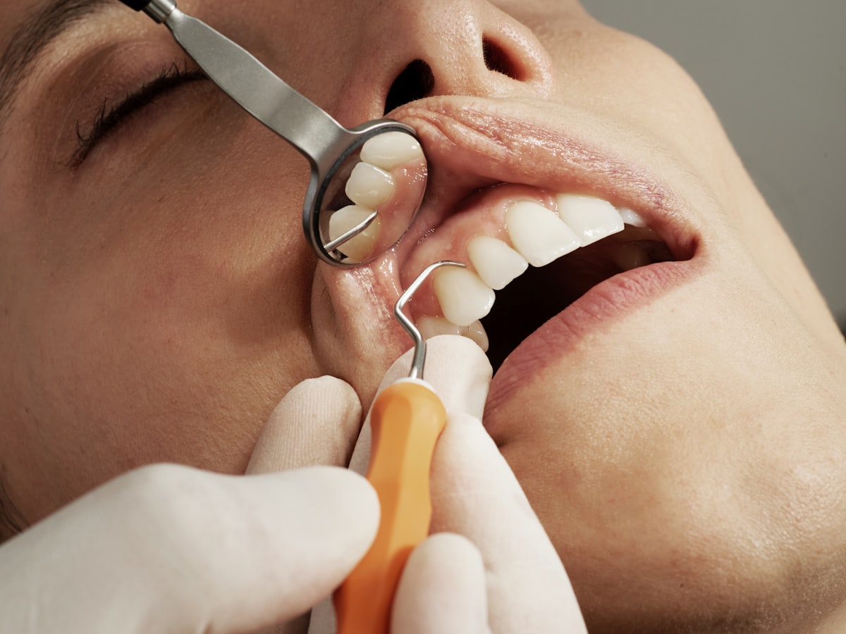 dental exam with mirror and tool